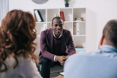 A therapist talks to a couple in therapy