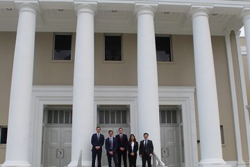 A small group stands in front of the Florida Supreme Court