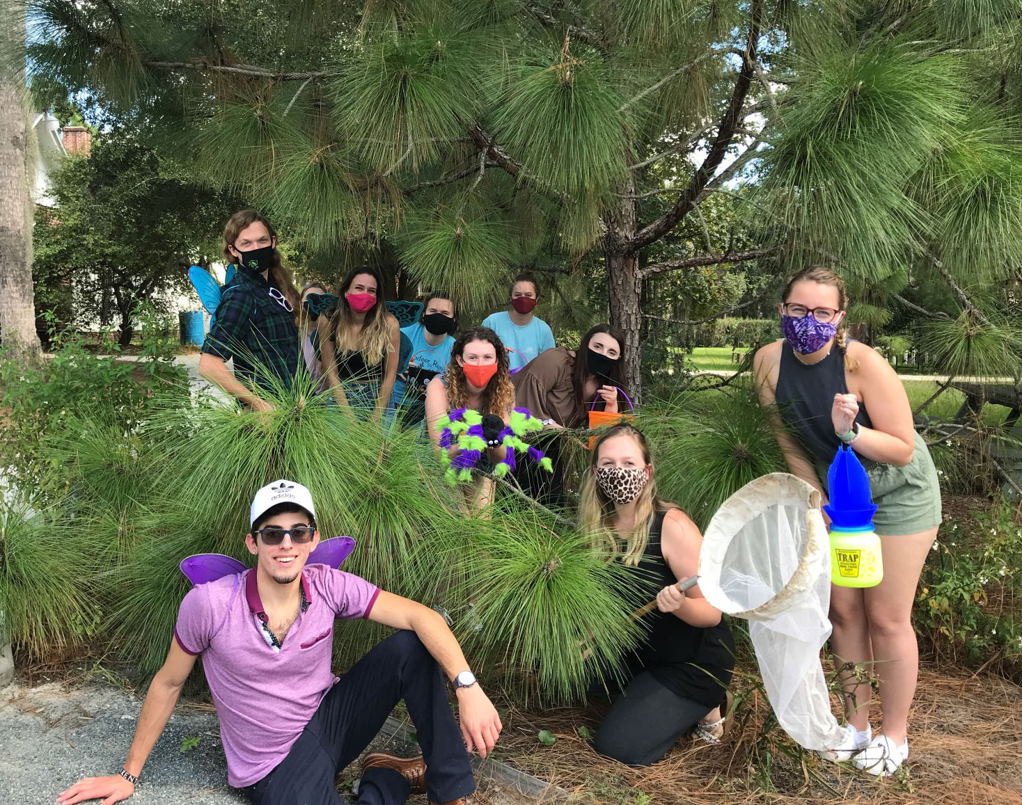 Group photo of students in Halloween costumes in a natural scene