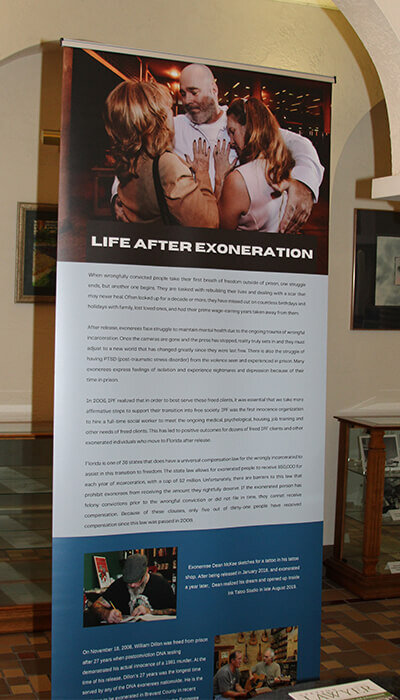 An exhibit display shows a man released from prison and reuniting with his family
