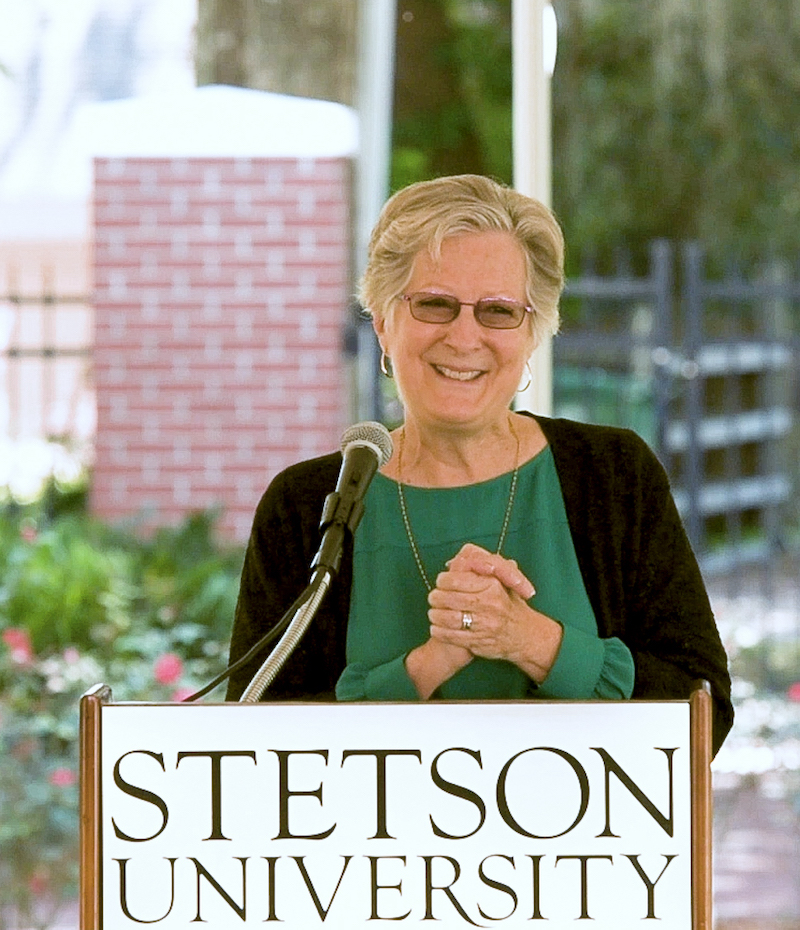 Kate Pearce speaks at podium during announcement about $15M for scholarships