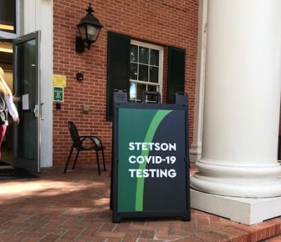 A sign outside the CUB announces COVID testing, for COVID-19 weekly update