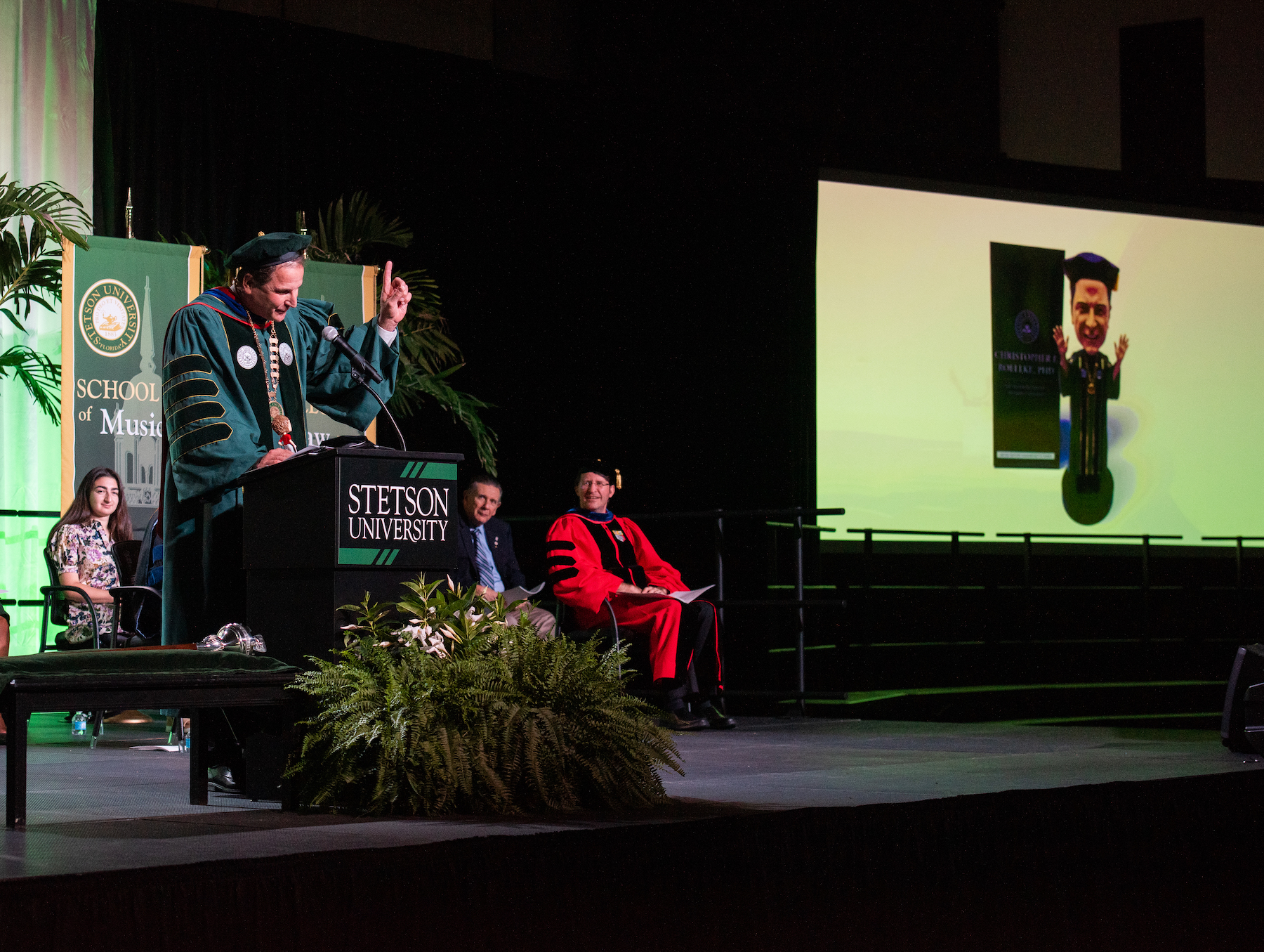 President Roellke speaks with an image of his limited edition bobbleheads on the screen