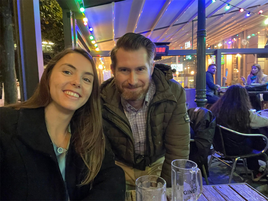 Two people pose in a restaurant in Europe