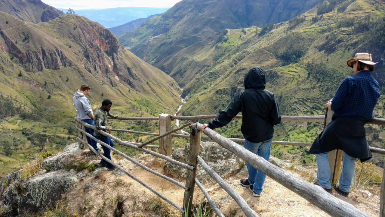 Students look at the sweeping landscape in Ecuador.