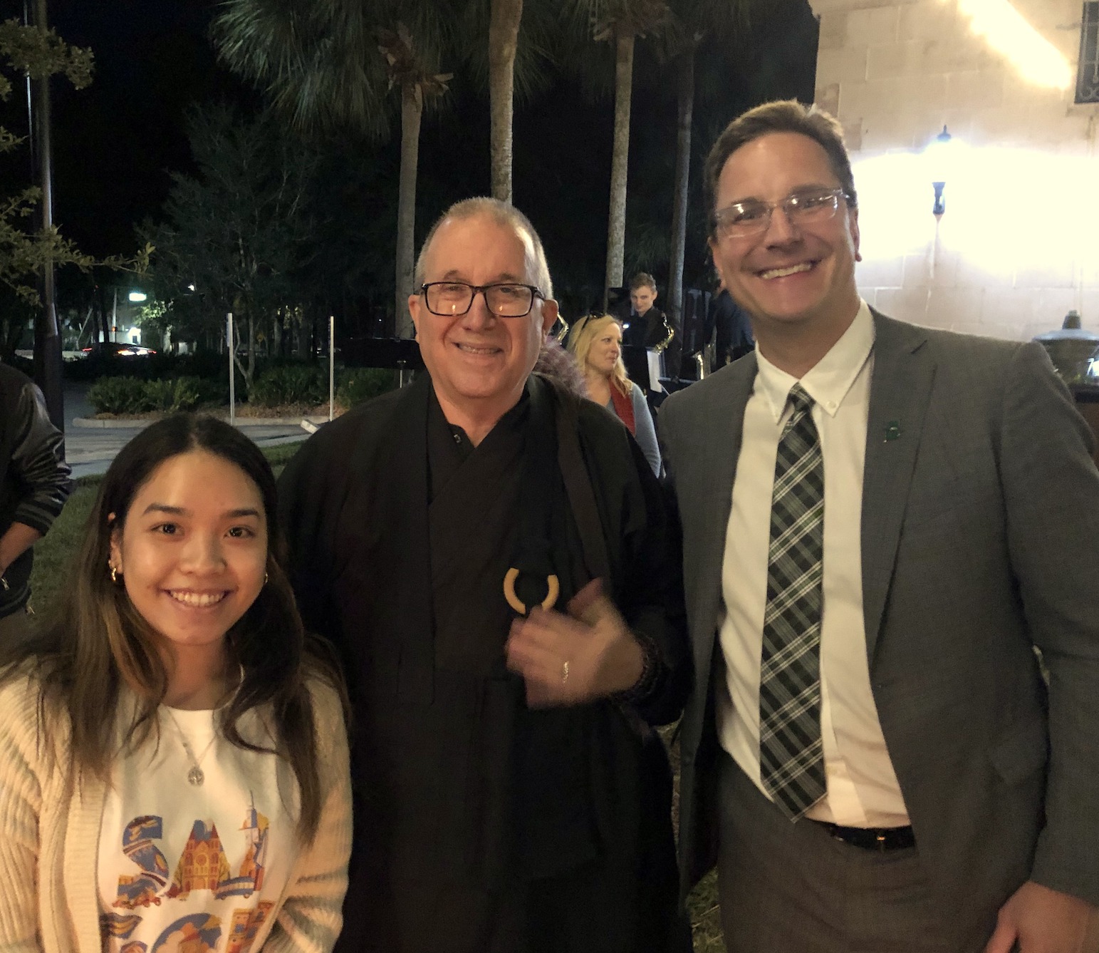 Three people pose for a snapshot at the Yule Log Lighting