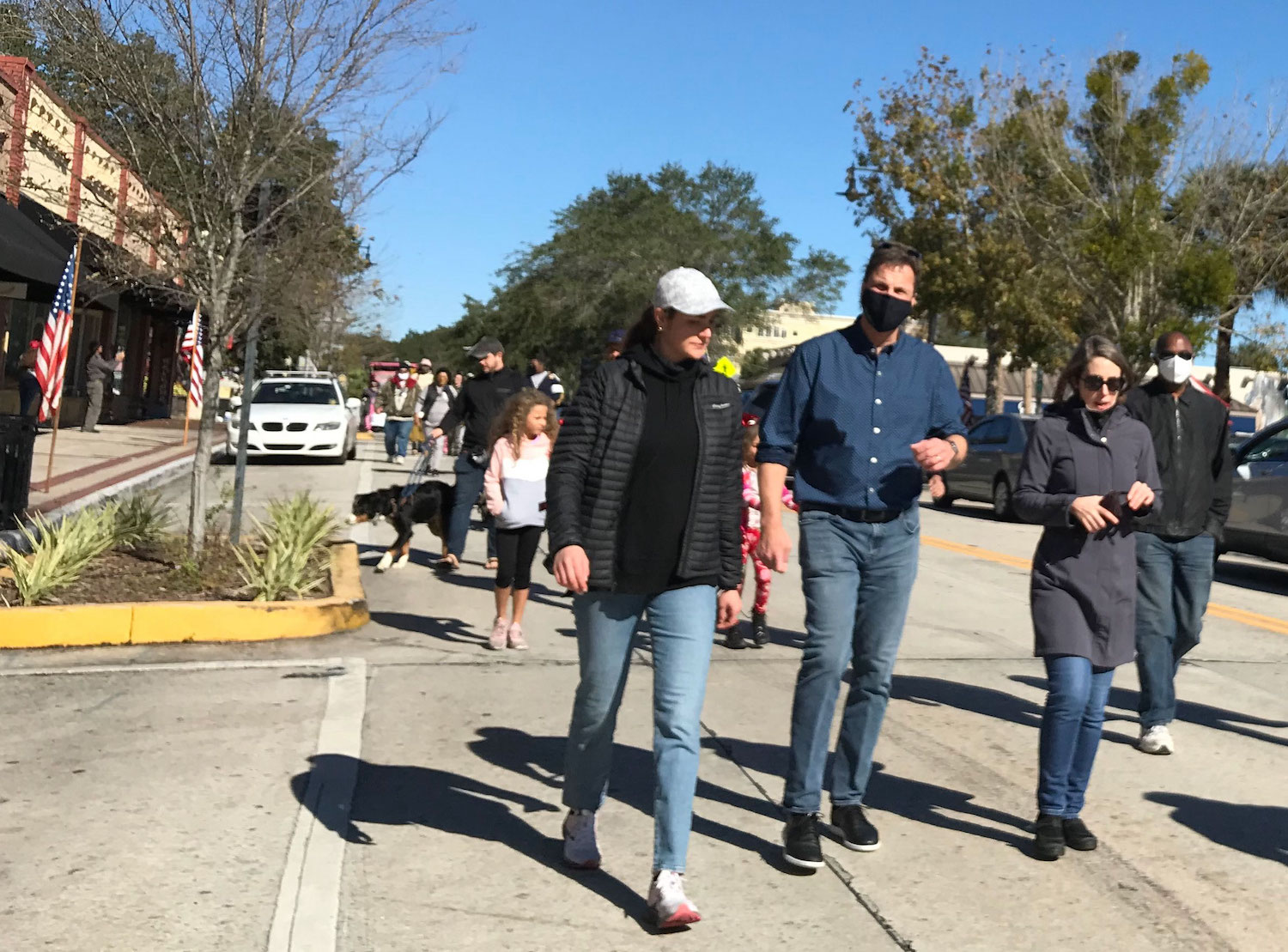 President Christopher Roellke, his daughter Julia and Elizabeth Skomp, dean of the College of Arts and Sciences, walk in the MLK Day march.