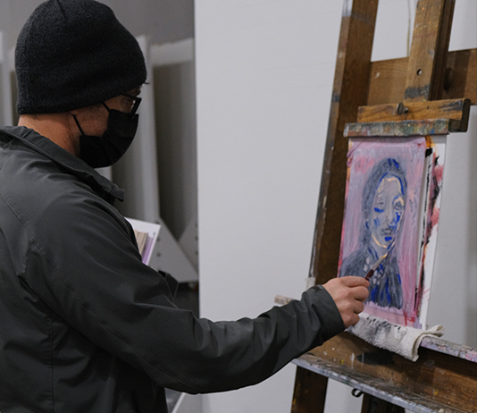 A student works on a painting