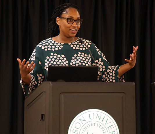 portrait of Marcia Chatelain speaking at the podium