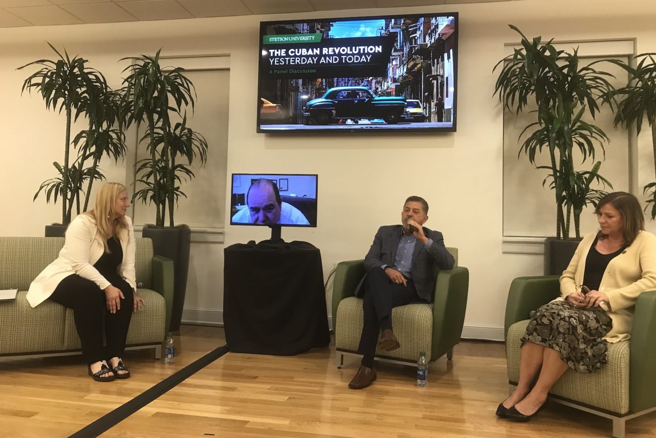 Panelists talk during a talk in Cuba