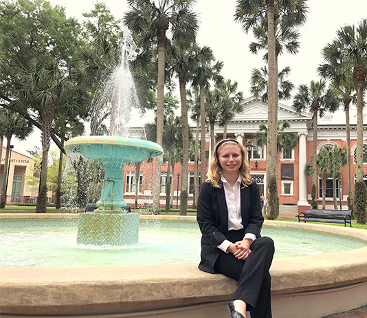Skye Cronje is seated beside Stetson fountain after she was awarded Newman Civic Fellowship