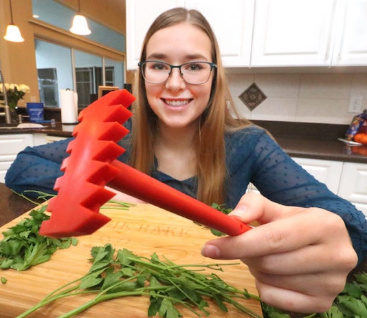 Kendall Buck holds her product in the kitchen, photo for Stetson in the News