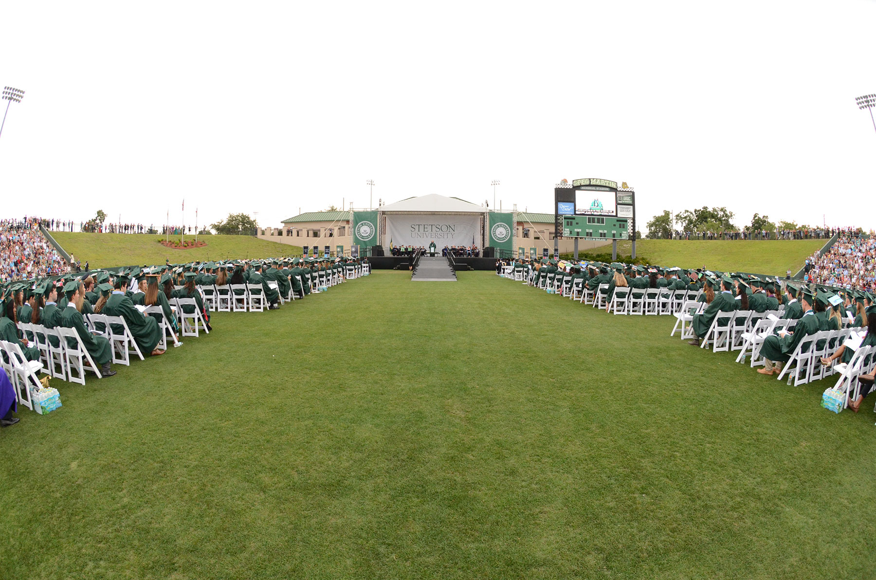 A sweeping shot of graduates and Commencement platform where students will give the Commencement address
