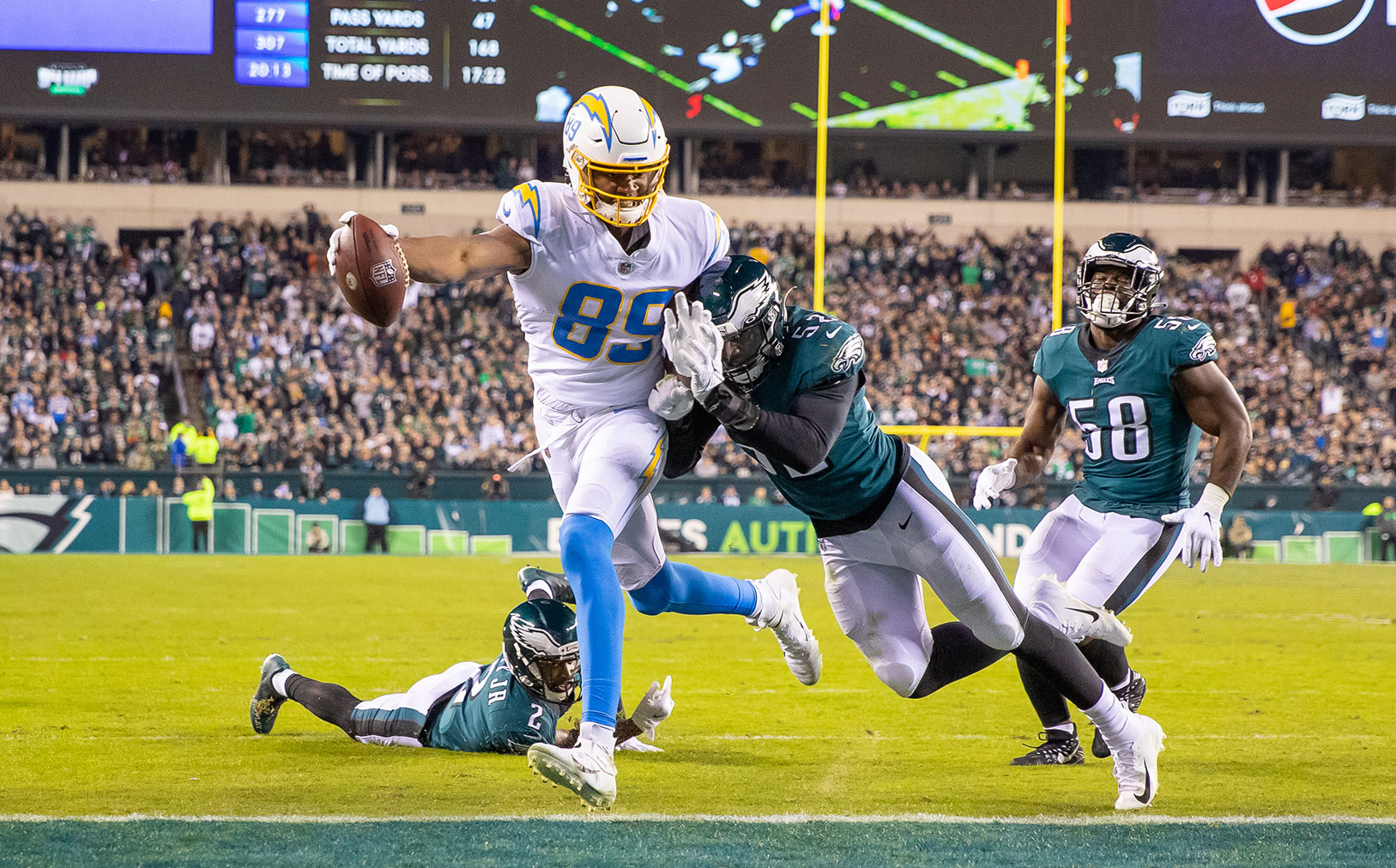 Donald Parham reaches into the end zone on the football field to make a touchdown.