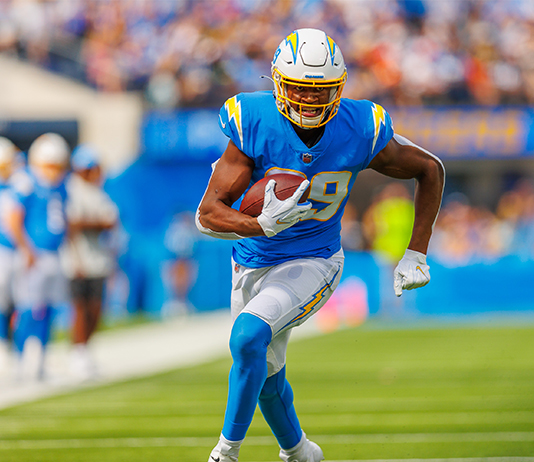 Donald Parham carries the ball on the football field