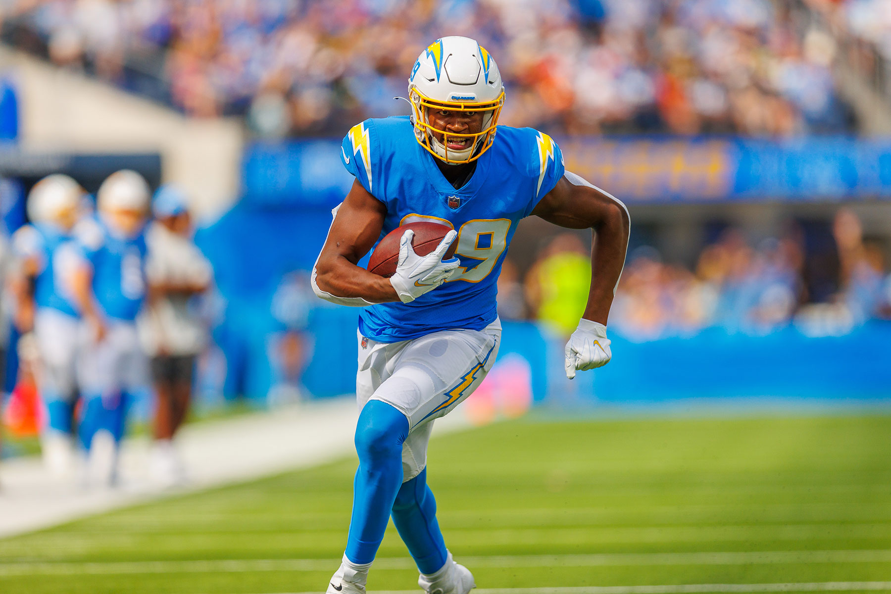 donald parham runs on the football field with the ball.