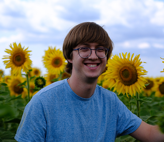 Jacob Mauser stands in a field of sunflowers in Ukraine