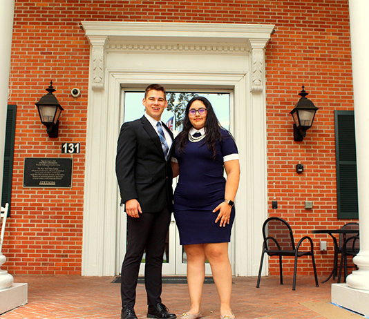 Two SGA officers stand in front of the CUB