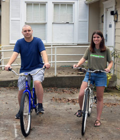 Two students pose with bicycles