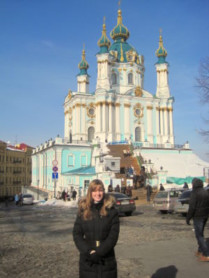 The student poses in front of a church in Ukraine