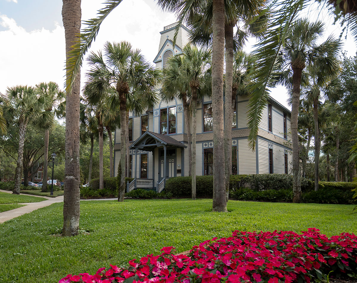 DeLand Hall exterior with flowers in the foreground.