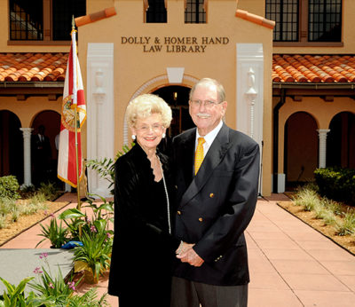 The couple stand in front of the Stetson Law Library