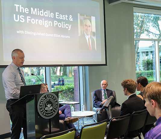 Members of an audience watch as a public speaking event begins
