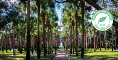 Scenic photo of Palm Court with a graphic badge that says, Green College 2025 by The Princeton Review