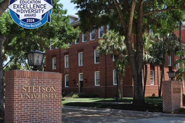 Accolade badge for the HEED Award is shown on a pretty campus scene.