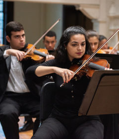 Student musicians play in an orchestra