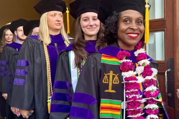 Graduates line up in Commencement regalia