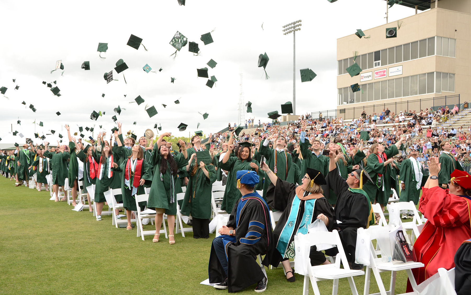 Graduates throw their caps in the air following the Commencement ceremony.