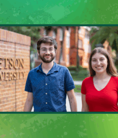 Two students stand in front of the Stetson gates