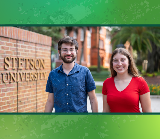 Two students stand in front of the Stetson gates