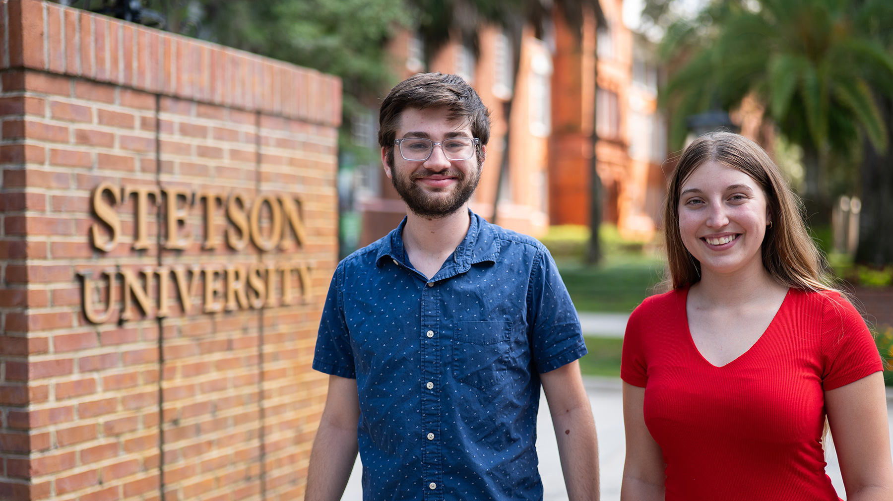 Two students stand in front of the Stetson Gates.