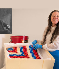 A woman displays a quilt