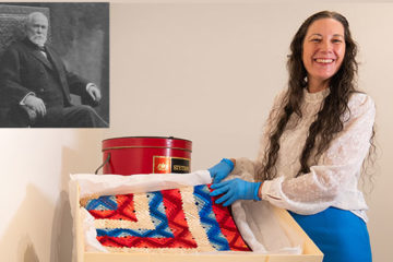 A woman displays a quilt