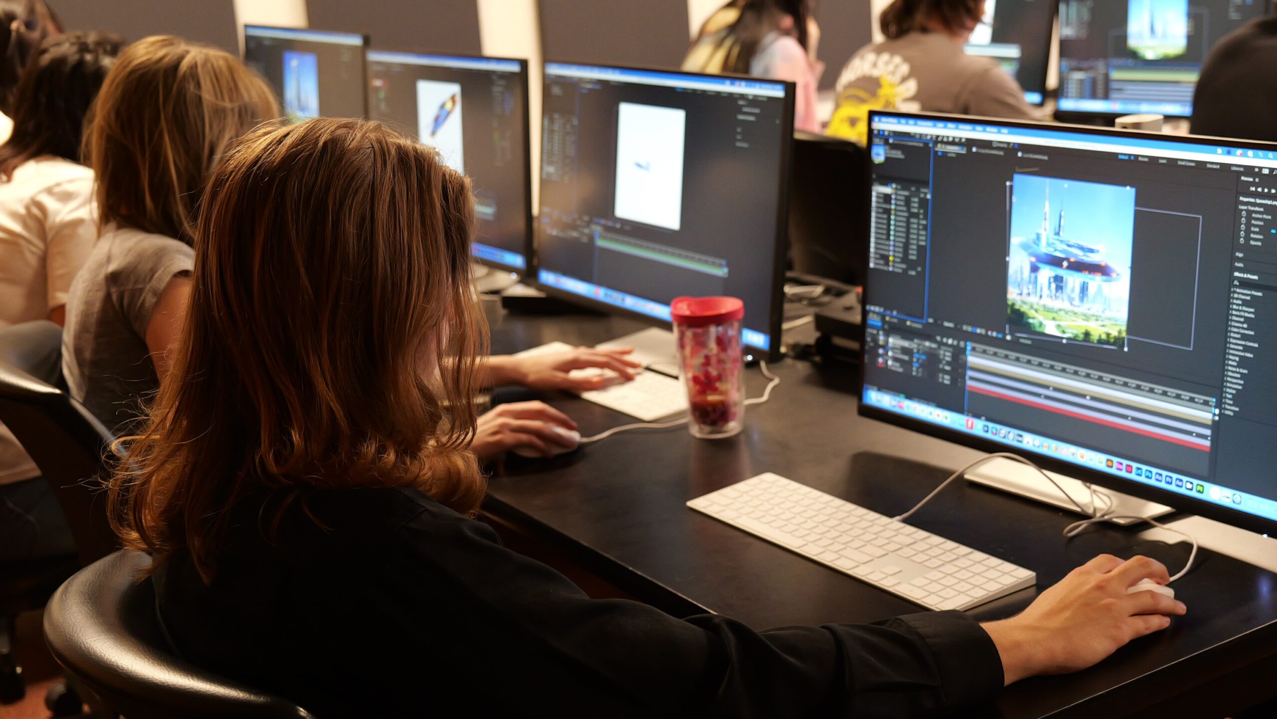 Students work on computers in a college class.