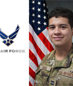 Portrait of a young man in military fatigues with a flag behind him and U.S, Air Force logo beside him.