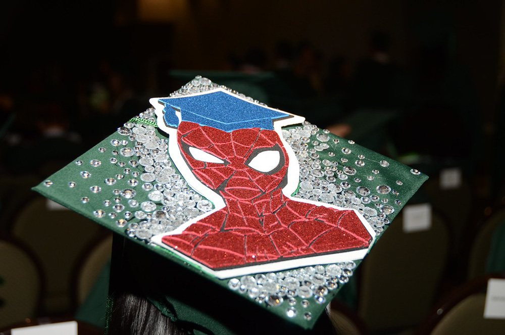 The top of a Commencement cap is decorated with Spiderman