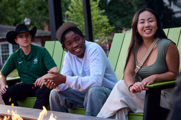 Students gather around the fire pit at Lynn Hall.