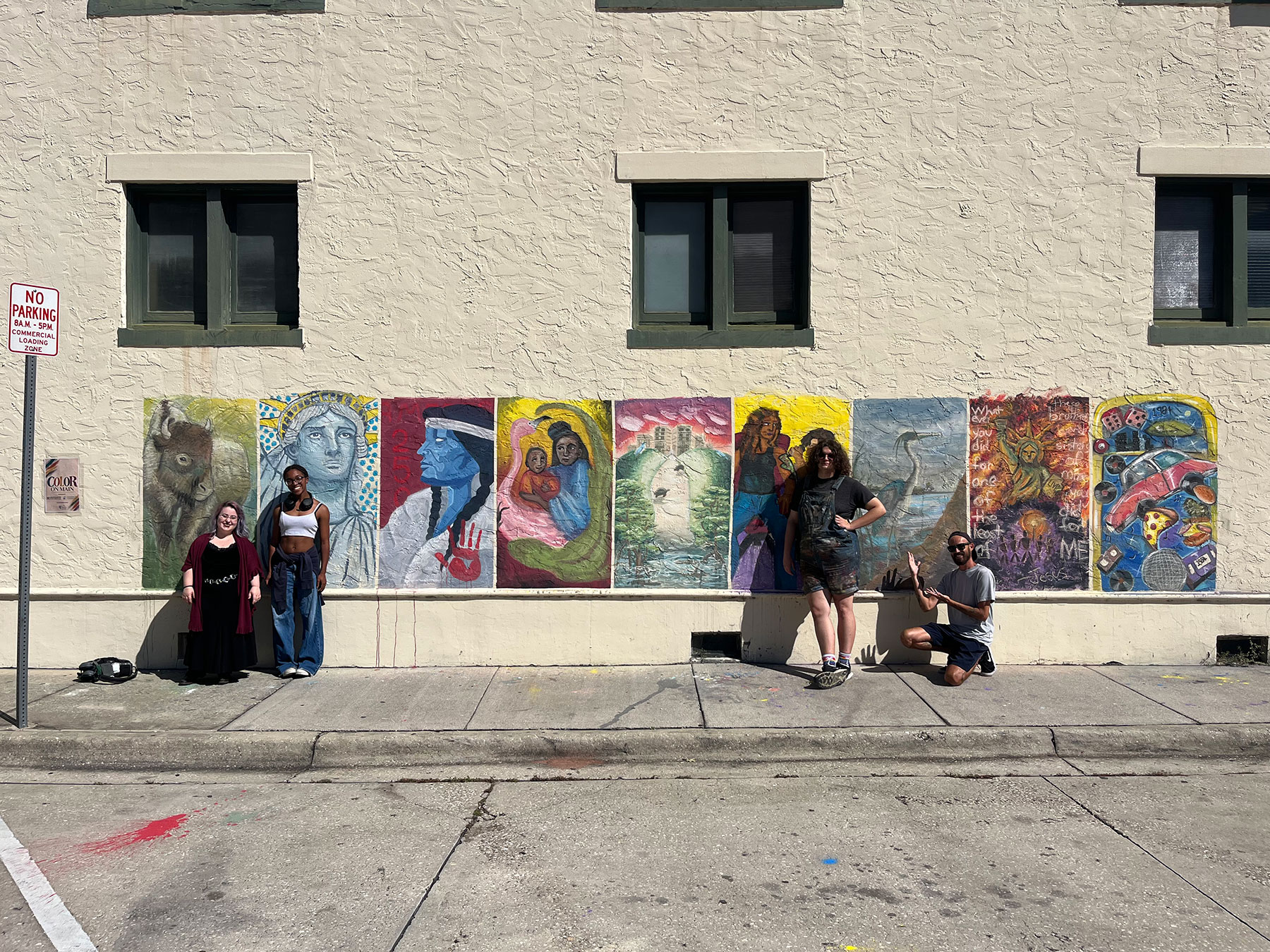 Students posing with their finished mural
