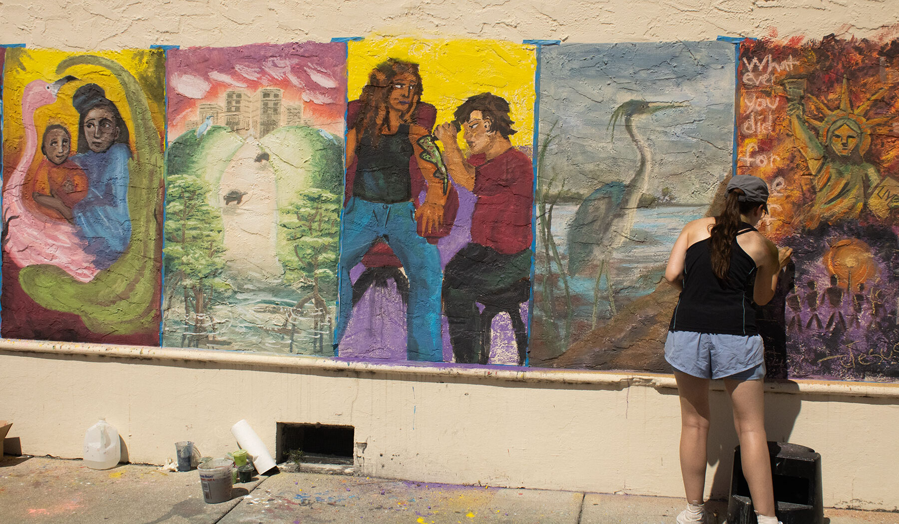Student working on her mural