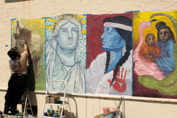 A student painting a mural