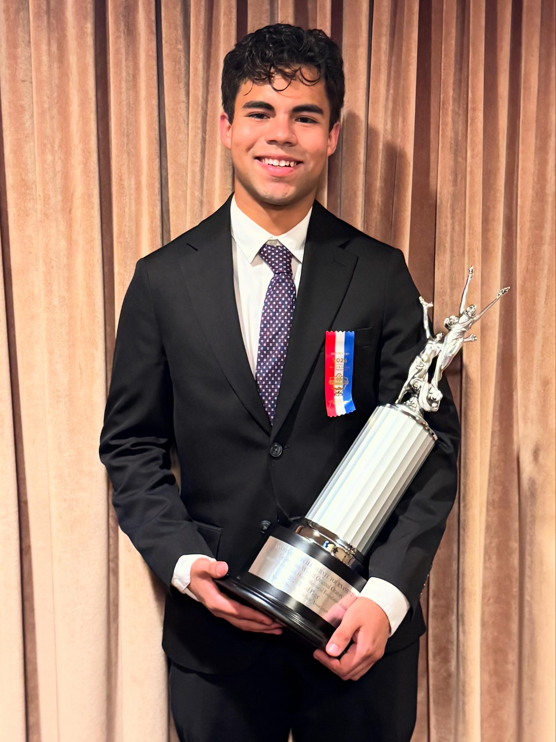Luis Latozefsky with his trophy for being the third-place winner at the National Speech and Debate Tournament