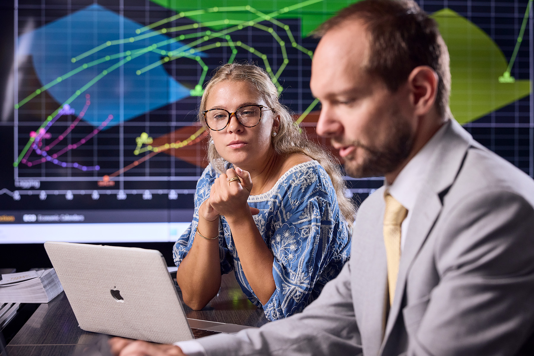 Professor and student working together in a trading room