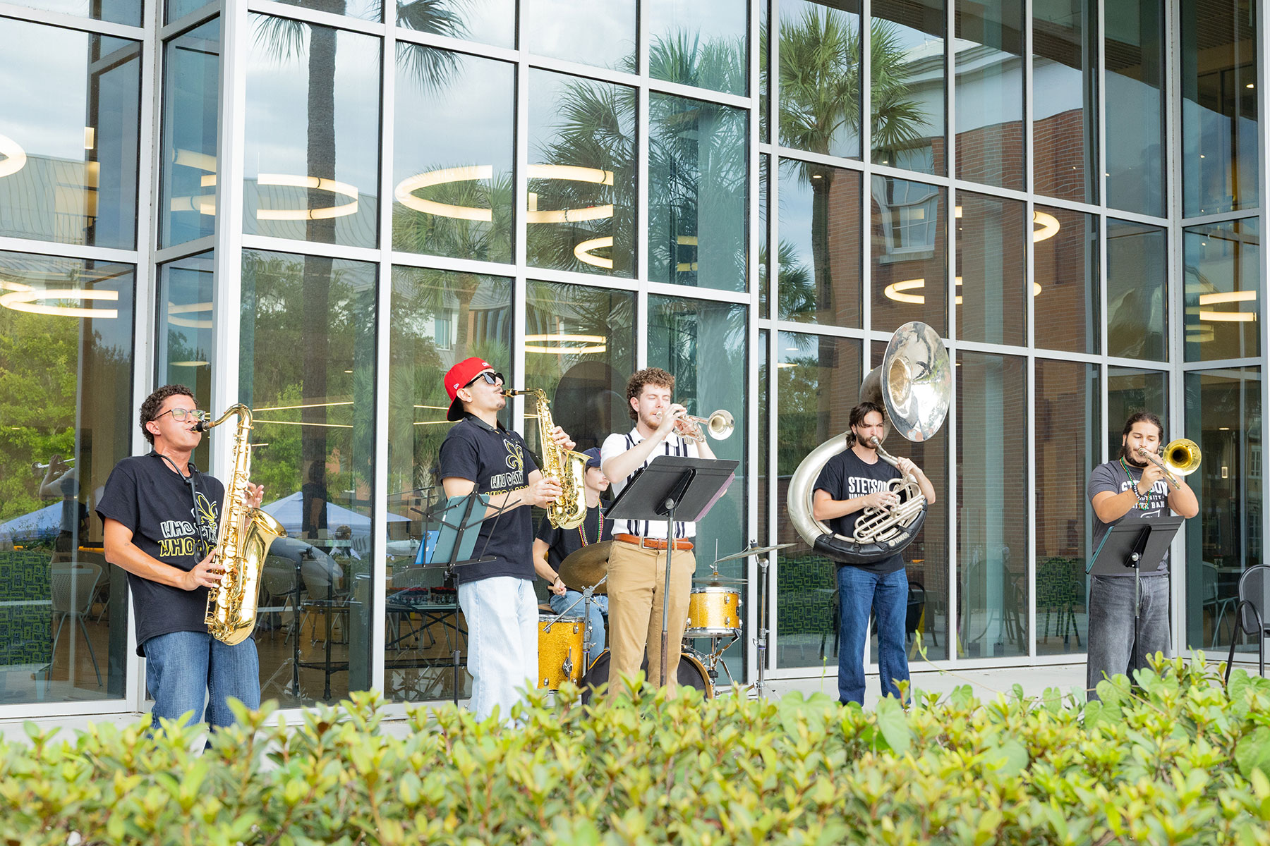 A brass band with five members performing