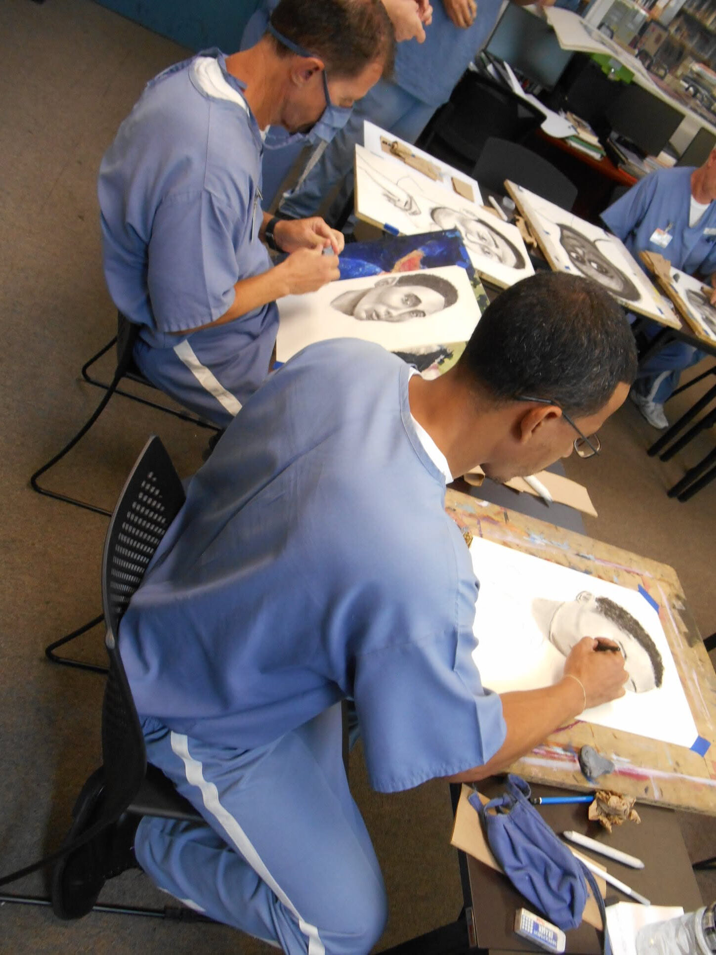 Incarcerated students drawing portraits
