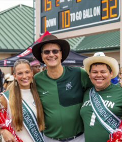 Homecoming king and queen with university president