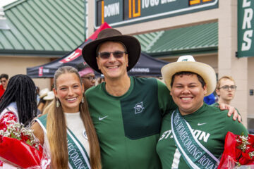 Homecoming king and queen with university president